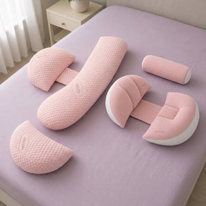 3-Piece Adjustable Maternity Pillow and Winged Maternity Pillow in pink, together on a bed
